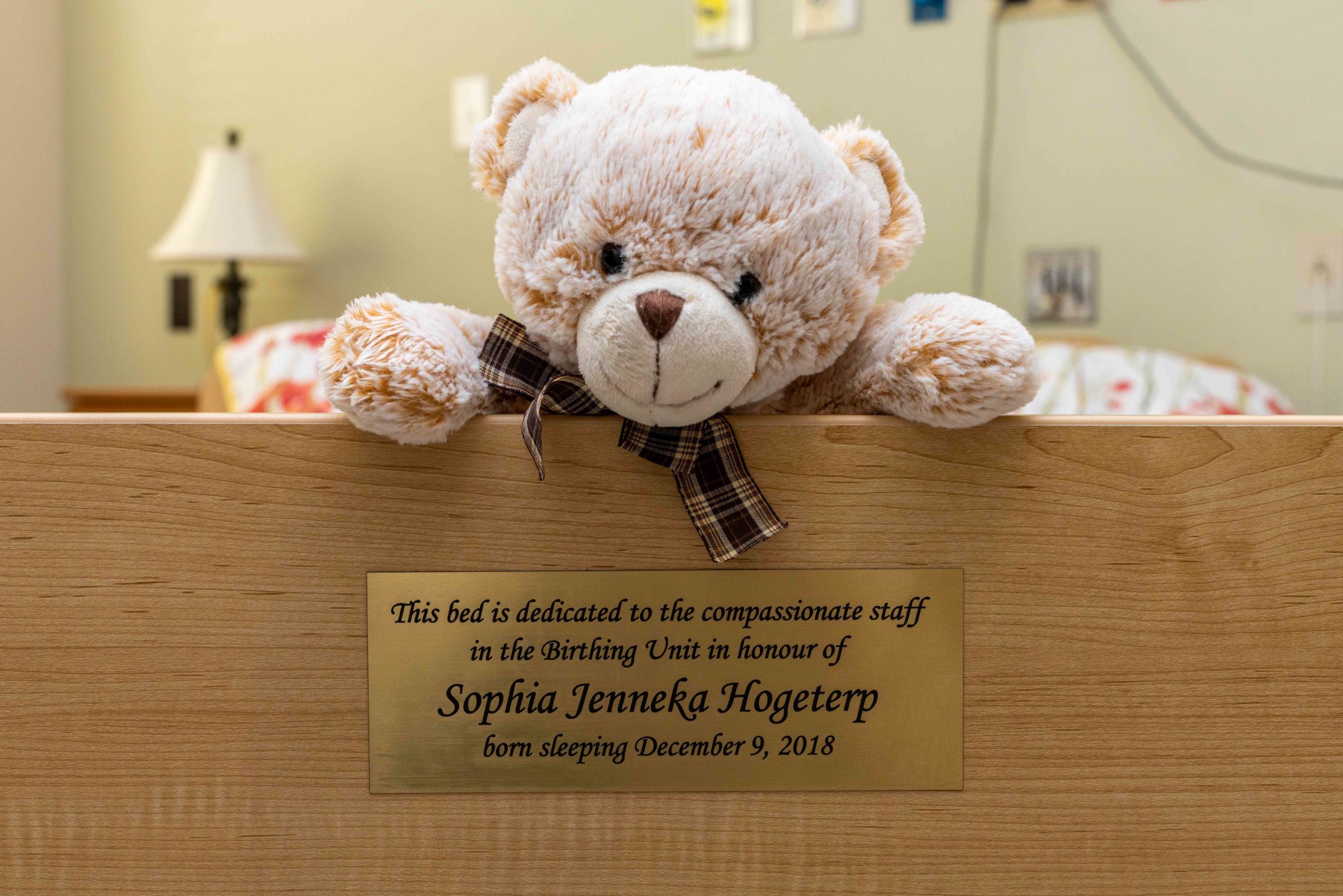 A teddy bear sits above a plaque on the footboard of the new bed in the family care suite that is dedicated to the compassionate staff in the Birthing Unit in loving memory of Sophia Jenneka Hogeterp, born sleeping on December 9, 2018.
