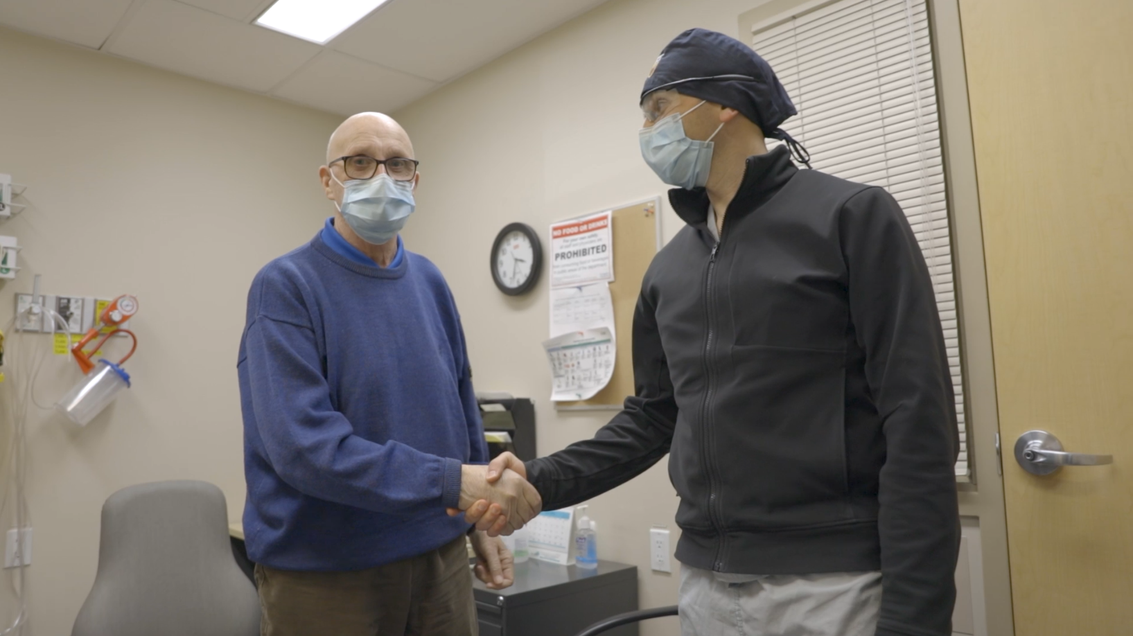 Dr. Waël Hanna stands on the right shaking hands with 74-year-old patient David Paterson 
